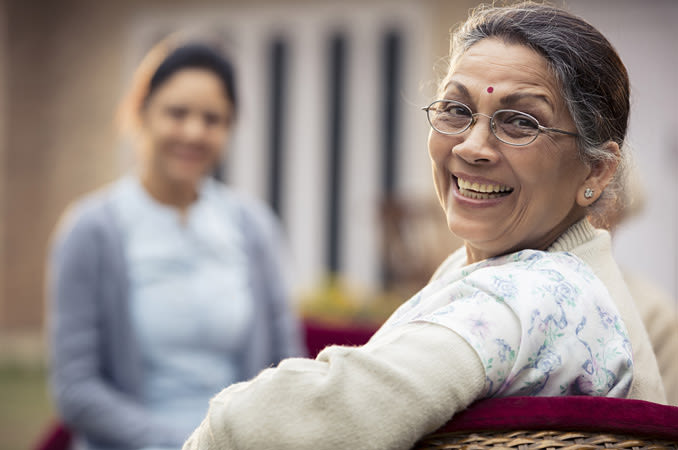 "Happy elderly woman prepared for cataract surgery at Shanthinethralaya Eye Hospital"