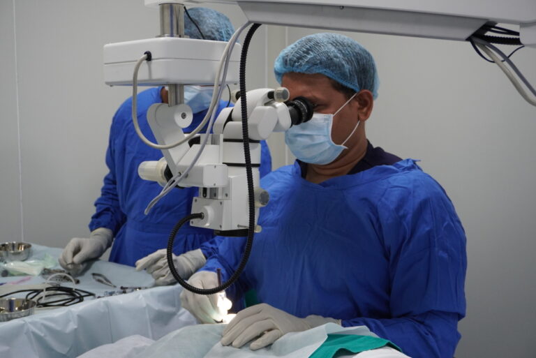 "Surgeon performing cataract surgery using a microscope."